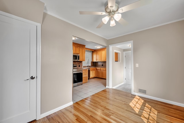 170 Morningside Dr E, Bristol, CT 06010 - kitchen featuring appliances with stainless steel finishes, ceiling fan, light wood-style floors, decorative backsplash, and baseboards