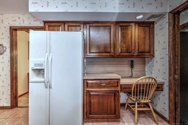 31 Country Ridge Dr, Monroe, CT 06468 - kitchen featuring white fridge with ice dispenser, light countertops, wallpapered walls, light tile patterned flooring, and built in desk