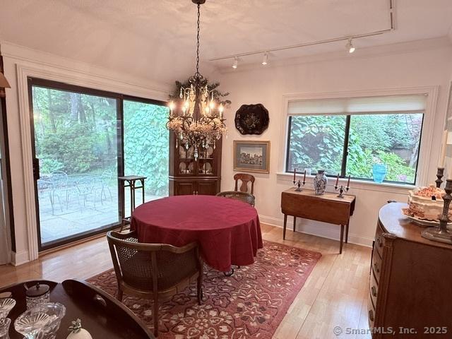 12 Heritage Crst Unit E, Southbury, CT 06488 - dining room with rail lighting, a chandelier, plenty of natural light, and light wood finished floors