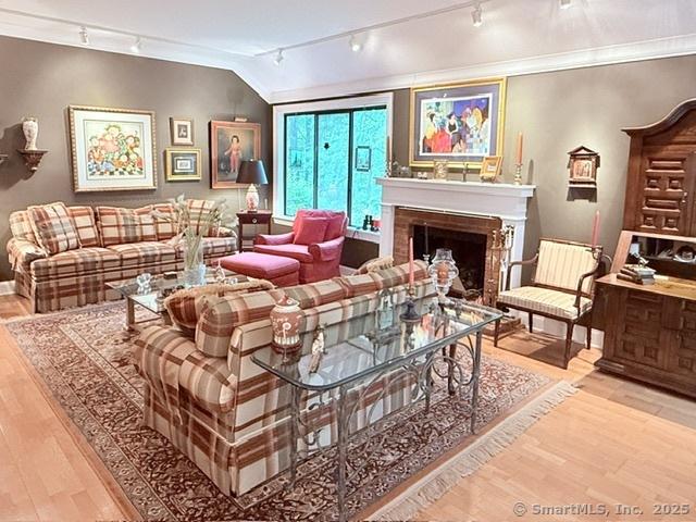 12 Heritage Crst Unit E, Southbury, CT 06488 - living room with rail lighting, wood finished floors, a fireplace, and crown molding