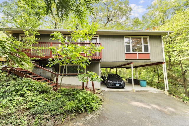 23 Rockmeadow Rd, Norwalk, CT 06850 - view of building exterior with driveway, a carport, and stairs