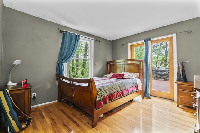23 Rockmeadow Rd, Norwalk, CT 06850 - bedroom with access to exterior, multiple windows, wood finished floors, and baseboards
