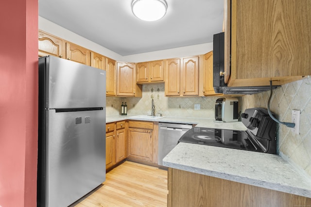 23 Rockmeadow Rd, Norwalk, CT 06850 - kitchen featuring appliances with stainless steel finishes, a sink, backsplash, light countertops, and light wood finished floors