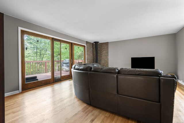 23 Rockmeadow Rd, Norwalk, CT 06850 - living room with a wood stove, light wood-style flooring, and baseboards