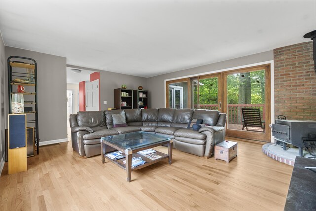 23 Rockmeadow Rd, Norwalk, CT 06850 - living room featuring a wood stove, light wood-style flooring, and baseboards