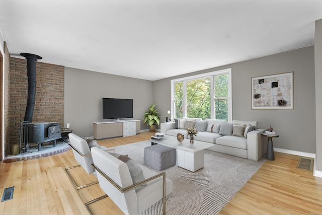 23 Rockmeadow Rd, Norwalk, CT 06850 - living area featuring a wood stove, wood finished floors, and baseboards