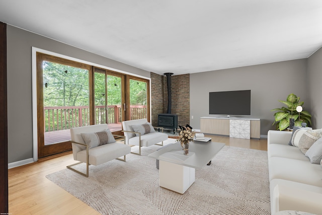23 Rockmeadow Rd, Norwalk, CT 06850 - living room featuring a wood stove, wood finished floors, and baseboards