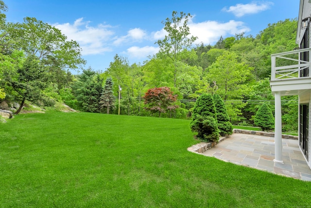 153 Valley Forge Rd, Weston, CT 06883 - view of green lawn featuring a patio area, a wooded view, and a balcony