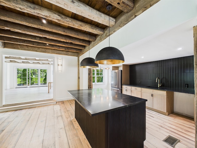 153 Valley Forge Rd, Weston, CT 06883 - kitchen featuring high end refrigerator, dark countertops, a sink, light wood-style flooring, and a center island