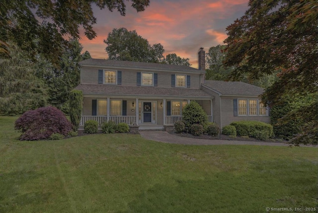 102 Pritchett Dr, Westbrook, CT 06498 - colonial inspired home featuring a chimney, a porch, and a front yard