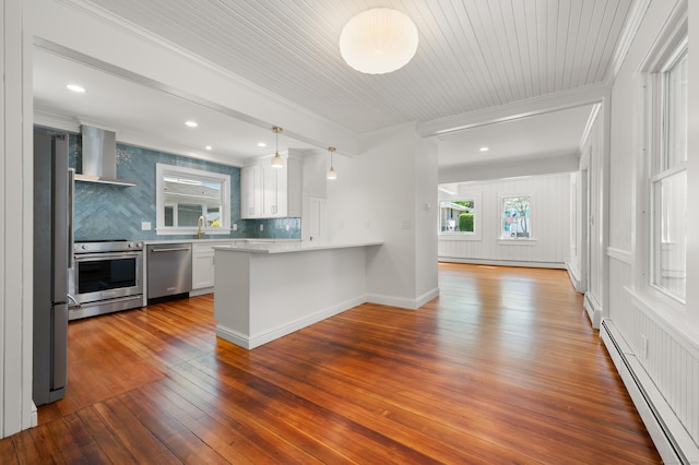 46 Park St, New London, CT 06320 - kitchen featuring appliances with stainless steel finishes, wall chimney range hood, a baseboard radiator, ornamental molding, and wood-type flooring