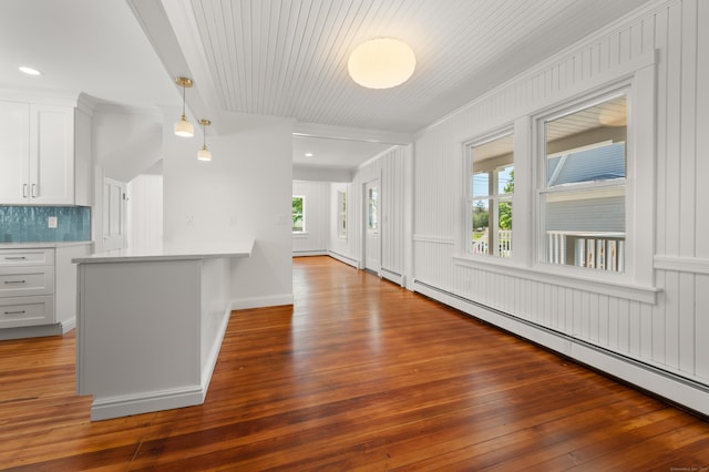46 Park St, New London, CT 06320 - kitchen featuring crown molding, a baseboard heating unit, hardwood / wood-style flooring, white cabinets, and tasteful backsplash