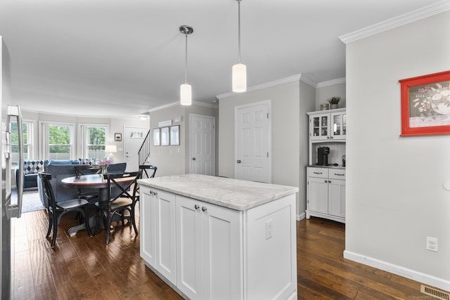 92 Lafayette St Apt 5, Stamford, CT 06902 - kitchen featuring dark wood finished floors, white cabinets, crown molding, decorative light fixtures, and a kitchen island