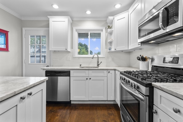 92 Lafayette St Apt 5, Stamford, CT 06902 - kitchen with stainless steel appliances, white cabinetry, tasteful backsplash, crown molding, and dark wood finished floors