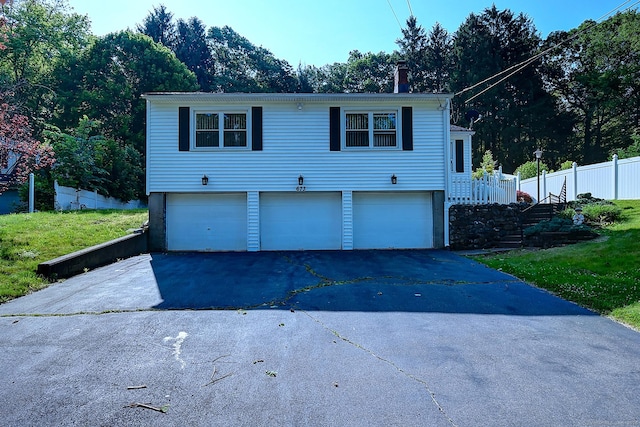 673 May St, Naugatuck, CT 06770 - view of front of home with a chimney and asphalt driveway