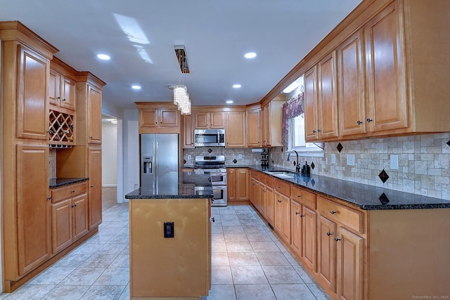 673 May St, Naugatuck, CT 06770 - kitchen with stainless steel appliances, a center island, dark stone countertops, backsplash, and recessed lighting