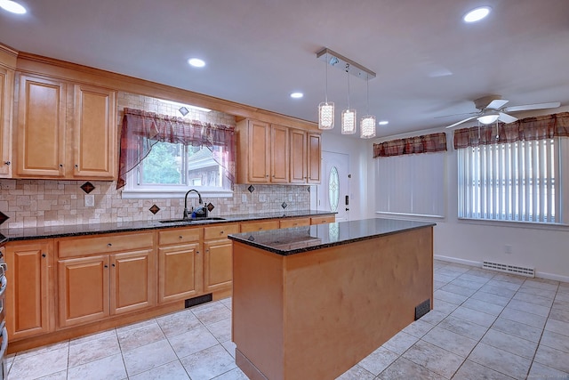 673 May St, Naugatuck, CT 06770 - kitchen with tasteful backsplash, light tile patterned flooring, a ceiling fan, dark stone counters, and a center island