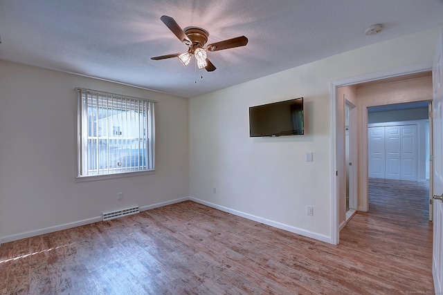 673 May St, Naugatuck, CT 06770 - empty room with wood finished floors, ceiling fan, a smoke detector, and a textured ceiling