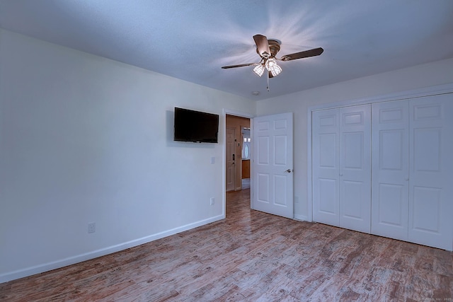 673 May St, Naugatuck, CT 06770 - unfurnished bedroom with wood finished floors, a closet, and a ceiling fan