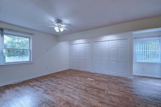 673 May St, Naugatuck, CT 06770 - unfurnished bedroom with multiple closets, wood finished floors, and a ceiling fan