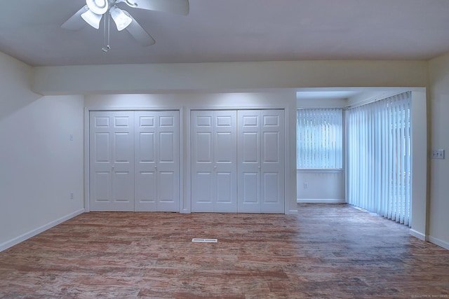 673 May St, Naugatuck, CT 06770 - unfurnished bedroom featuring two closets, wood finished floors, and ceiling fan