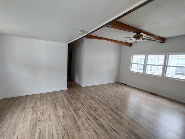 29 Hemlock Dr, Shelton, CT 06484 - unfurnished living room featuring a ceiling fan, light wood finished floors, beamed ceiling, and baseboards