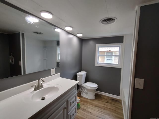 29 Hemlock Dr, Shelton, CT 06484 - bathroom featuring toilet, vanity, wood finished floors, a tub to relax in, and baseboards