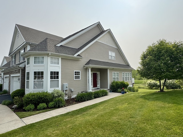 22 Pebble Beach Dr Unit 22, Bloomfield, CT 06002 - view of front of home with a shingled roof and a front lawn