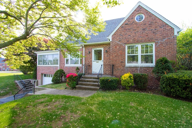 662 Jones Hill Rd, West Haven, CT 06516 - view of front facade featuring brick siding, a front lawn, and a garage