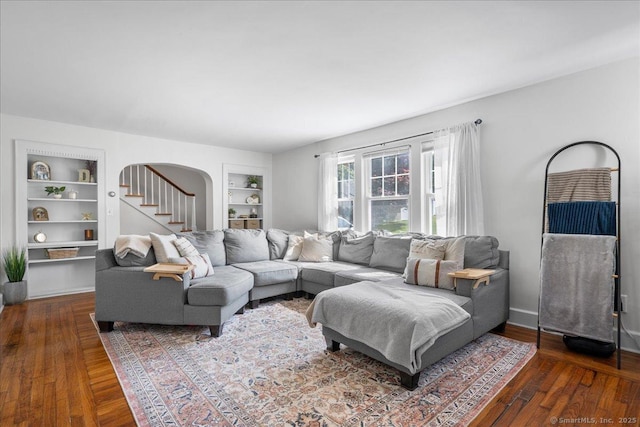 17 Wild Rose Pl, Waterford, CT 06385 - living room featuring built in shelves, arched walkways, and hardwood / wood-style floors
