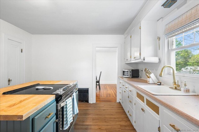 17 Wild Rose Pl, Waterford, CT 06385 - kitchen featuring electric stove, a sink, white cabinetry, wood finished floors, and wooden counters