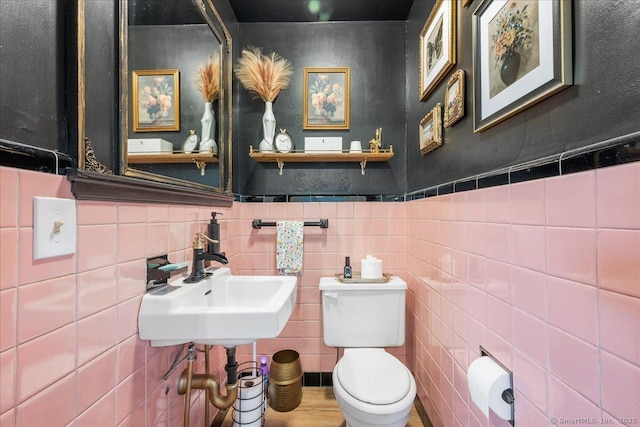 17 Wild Rose Pl, Waterford, CT 06385 - half bathroom featuring toilet, a sink, and a wainscoted wall