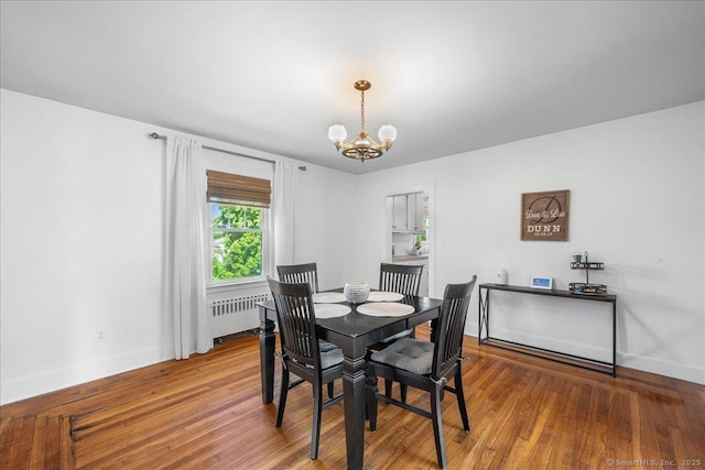 17 Wild Rose Pl, Waterford, CT 06385 - dining area with radiator heating unit, a chandelier, baseboards, and wood finished floors