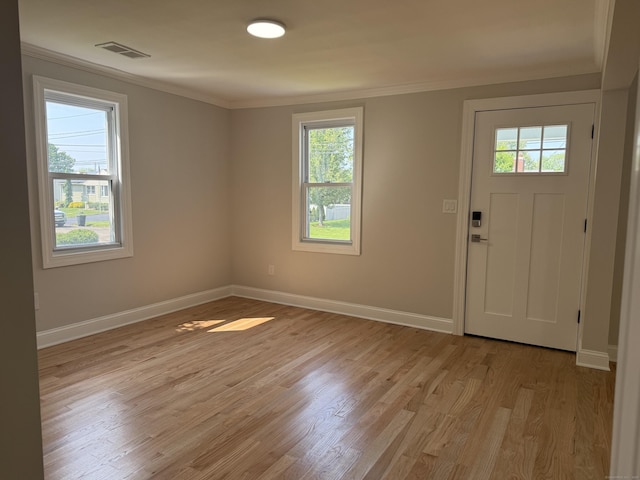 42 Waldo St, East Haven, CT 06512 - foyer with healthy amount of natural light, ornamental molding, baseboards, and light wood-style floors