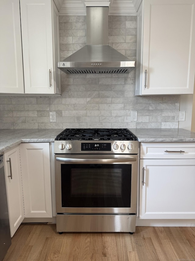42 Waldo St, East Haven, CT 06512 - kitchen with stainless steel gas range, wall chimney exhaust hood, backsplash, and white cabinets