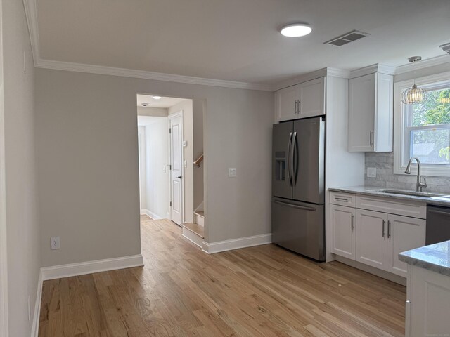 42 Waldo St, East Haven, CT 06512 - kitchen featuring stainless steel appliances, a sink, baseboards, ornamental molding, and white cabinets