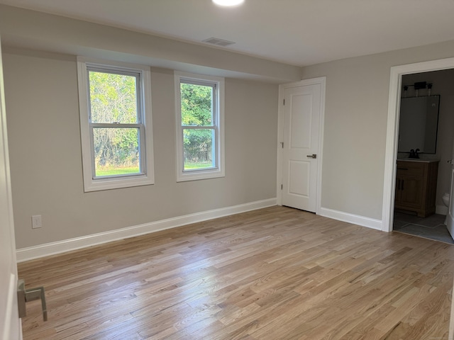 42 Waldo St, East Haven, CT 06512 - unfurnished bedroom featuring light wood-style floors, baseboards, ensuite bath, and a sink