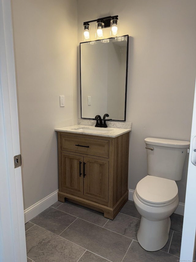 42 Waldo St, East Haven, CT 06512 - half bathroom with vanity, baseboards, and toilet
