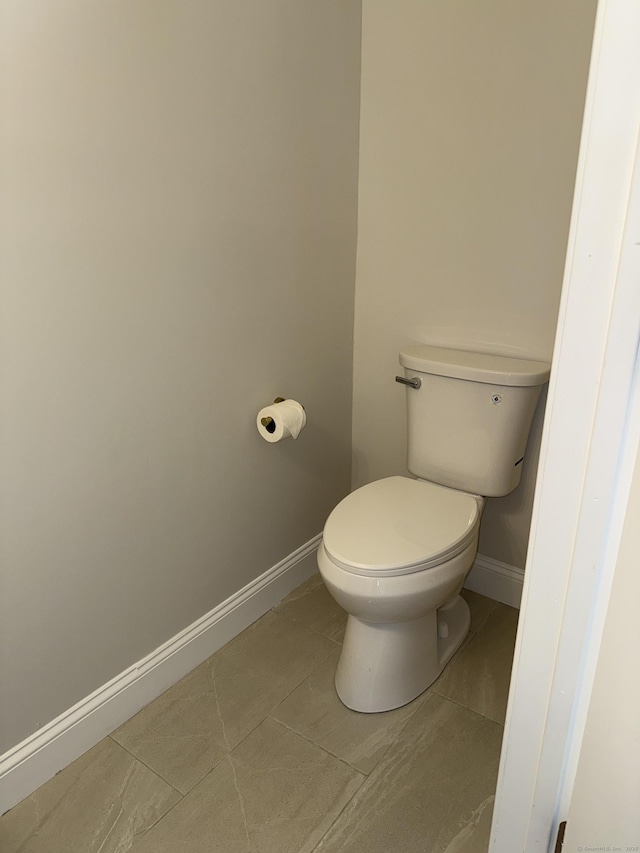 42 Waldo St, East Haven, CT 06512 - bathroom with baseboards, tile patterned flooring, and toilet