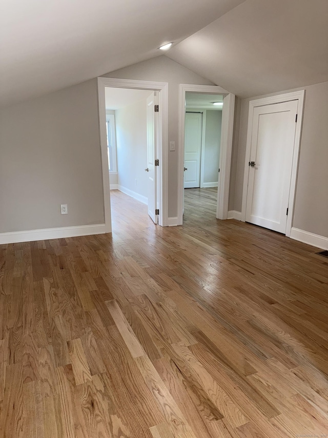 42 Waldo St, East Haven, CT 06512 - spare room with wood finished floors, lofted ceiling, and baseboards