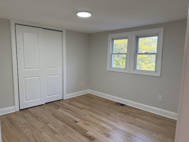 42 Waldo St, East Haven, CT 06512 - unfurnished bedroom with light wood-type flooring, baseboards, and a closet