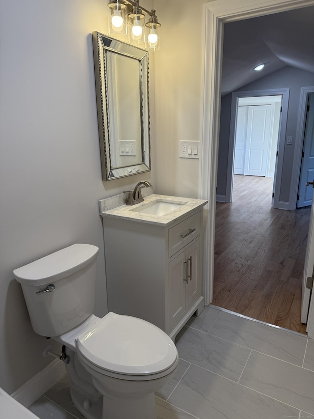 42 Waldo St, East Haven, CT 06512 - bathroom featuring toilet, vanity, and lofted ceiling