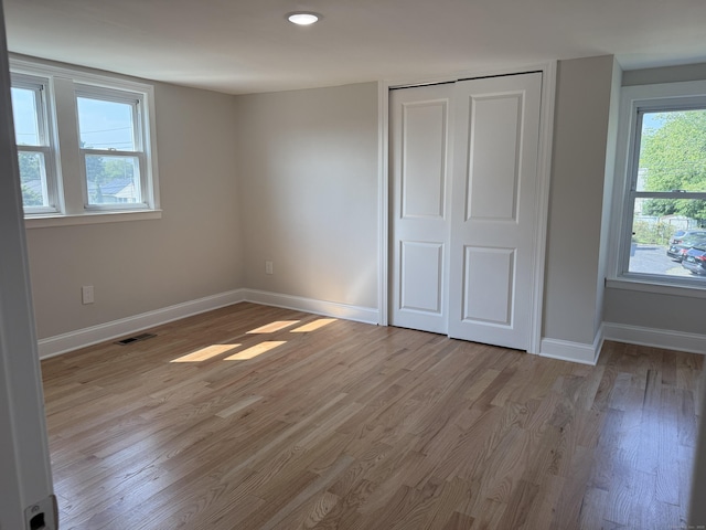 42 Waldo St, East Haven, CT 06512 - unfurnished bedroom featuring light wood-style flooring, baseboards, and a closet