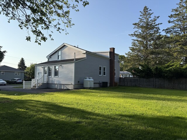 42 Waldo St, East Haven, CT 06512 - rear view of property with a chimney and central air condition unit