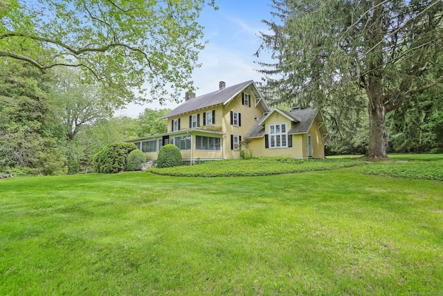 12 Lords Hwy E, Weston, CT 06883 - rear view of property featuring a chimney, a yard, and a sunroom