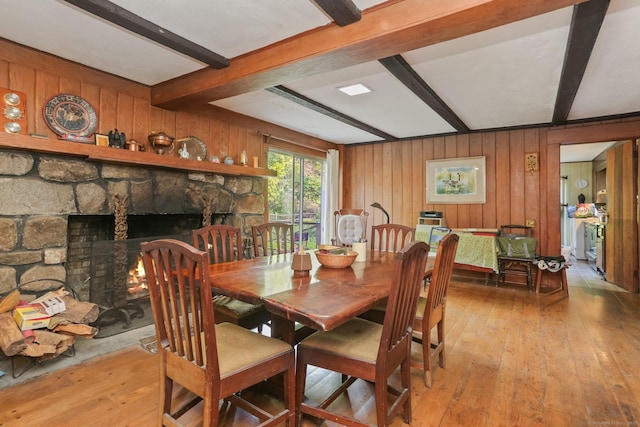 12 Lords Hwy E, Weston, CT 06883 - dining area featuring beamed ceiling, hardwood / wood-style floors, wood walls, and a stone fireplace