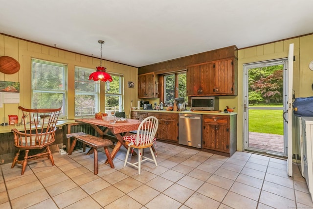 12 Lords Hwy E, Weston, CT 06883 - kitchen featuring stainless steel appliances, light tile patterned floors, wooden walls, light countertops, and pendant lighting