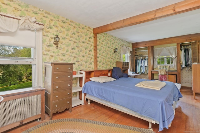 12 Lords Hwy E, Weston, CT 06883 - bedroom featuring wallpapered walls, wood finished floors, beamed ceiling, and multiple closets