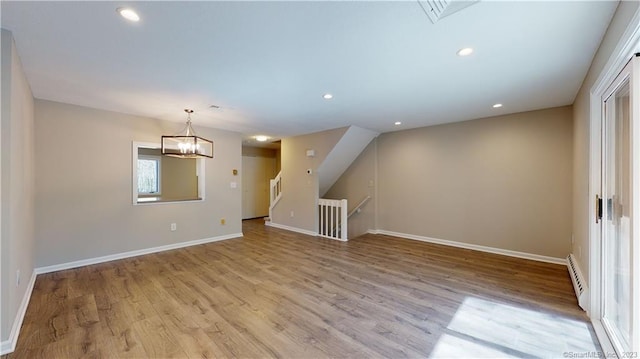 12 Cardinal Dr Unit 12, Farmington, CT 06032 - empty room featuring a baseboard heating unit, light wood-style floors, baseboards, a chandelier, and recessed lighting