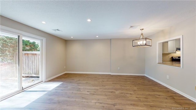 12 Cardinal Dr Unit 12, Farmington, CT 06032 - spare room featuring a chandelier, baseboards, light wood finished floors, and recessed lighting